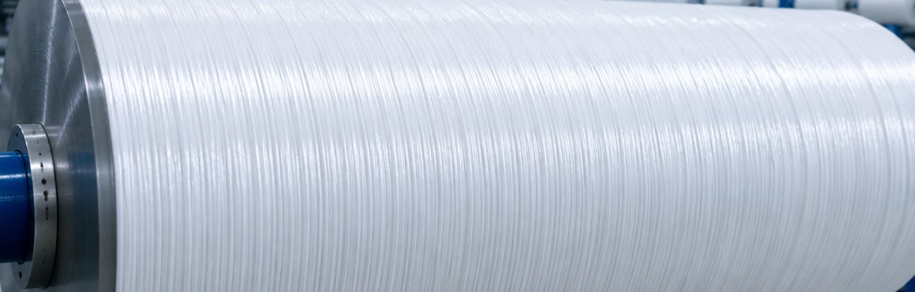 Bright white spun polyester warp yarn on the beam