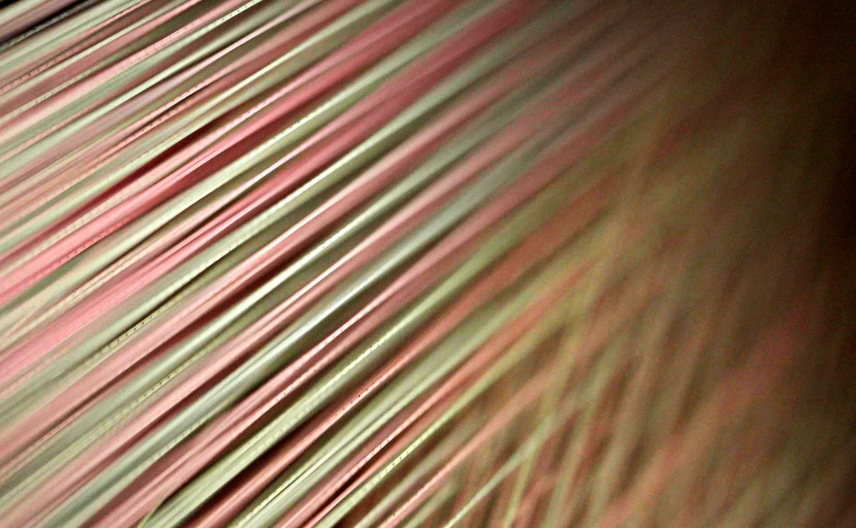 Warp yarn under tension during sizing
