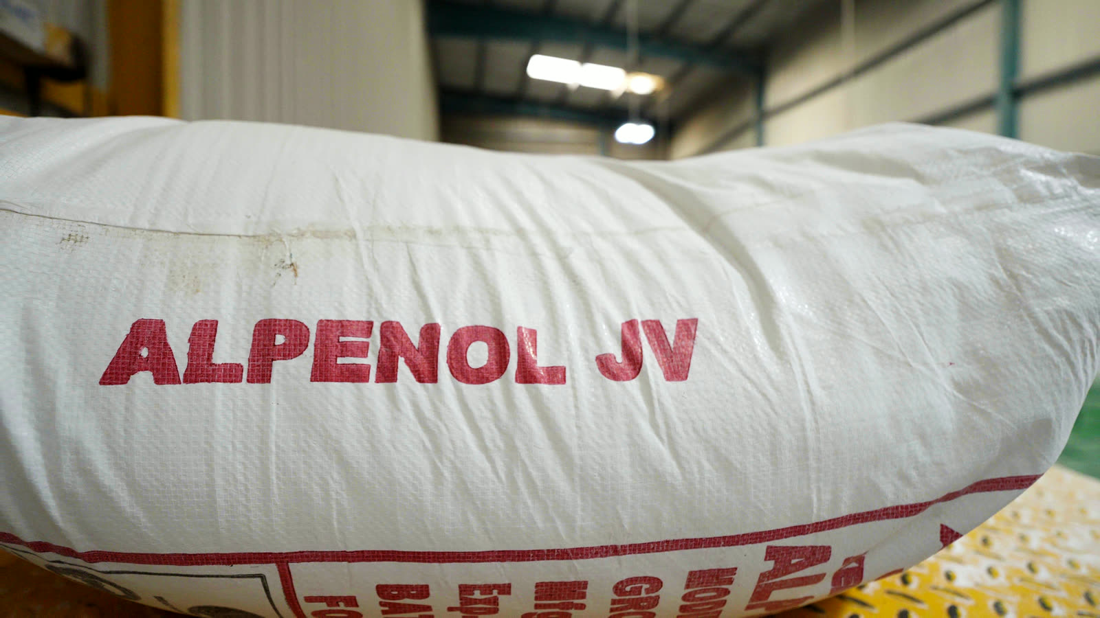 A bag of Alpenol JV going into the mixer